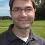 man with glasses and gray shirt